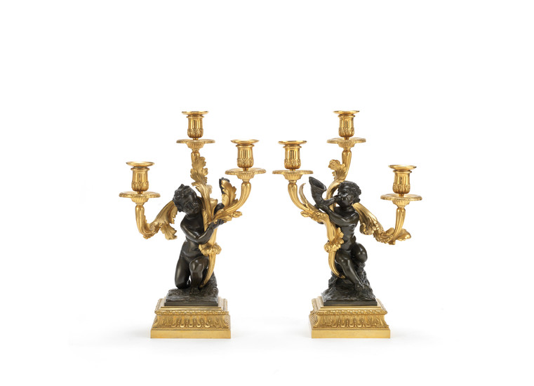 A pair of mid-19th century gilt and patinated bronze three-light figural candelabre