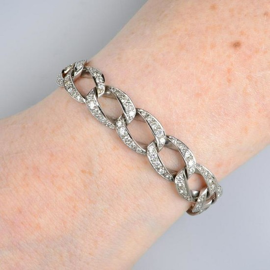 A pave-set diamond curb-link bracelet. Estimated total