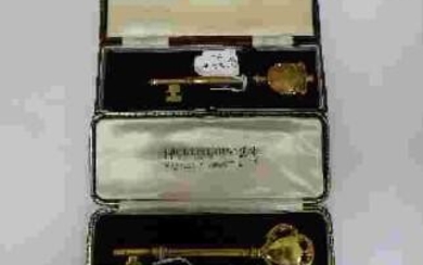 A silver-gilt presentation key, London, 1936, Hicklenton & Phillips, 11.5cm, surmounted with shield and c-scrolls, the obverse engraved GERMAN HOSPITAL, the reverse OPENED BY BARONESS v SCHRODER, in fitted case, weight approx. 37g; together with a...