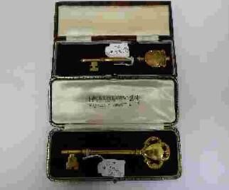 A silver-gilt presentation key, London, 1936, Hicklenton & Phillips, 11.5cm, surmounted with shield and c-scrolls, the obverse engraved GERMAN HOSPITAL, the reverse OPENED BY BARONESS v SCHRODER, in fitted case, weight approx. 37g; together with a...