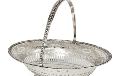 A small George III swing-handled silver basket, London, 1785, Hester Bateman, of oval form and raised on a pierced oval foot, the vertically pierced sides to a bright cut engraved and pierced foliate twist border, the handle and rim designed with...