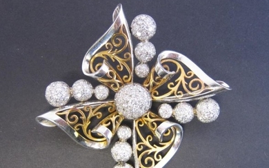 A two coloured Gold and Diamond Brooch of stylised...