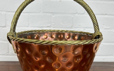 AN ARTS AND CRAFTS COPPER BASKET WITH ROPE TWIST...