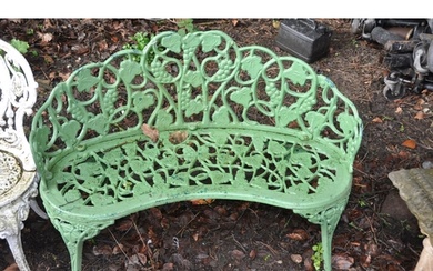 AN EARLY 20TH CENTURY PAINTED CAST IRON CURVED GARDEN SEAT f...