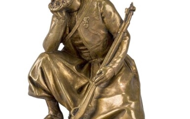 After Emmanuel Fremiet, French, 1824-1910, a polished bronze model of a Turk, late 19th century, depicted seated holding a rifle, the naturalistic base with cast signature E FREMIET., 21cm high