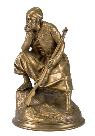 After Emmanuel Fremiet, French, 1824-1910, a polished bronze model of a Turk, late 19th century, depicted seated holding a rifle, the naturalistic base with cast signature E FREMIET., 21cm high
