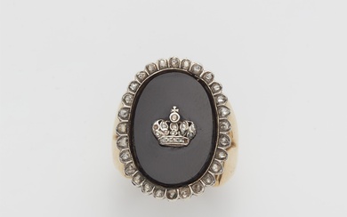 An 18k gold onyx and jewelled crown ring.