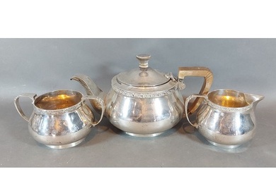 An Art Deco London silver three piece tea service comprising...