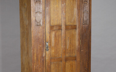 An Edwardian Arts and Crafts oak wardrobe, in the manner of Shapland & Petter, the overhanging p