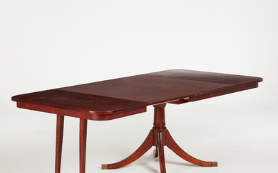 An English style dining table, second half of the 20th century, mahogany veneer, on a four-piece pillar base with brass leg ends, 2 inserts.
