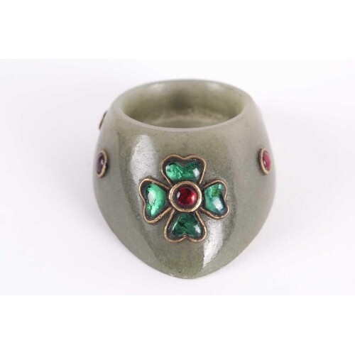 An Indian moss green jade archer's ring yellow metal set wit...