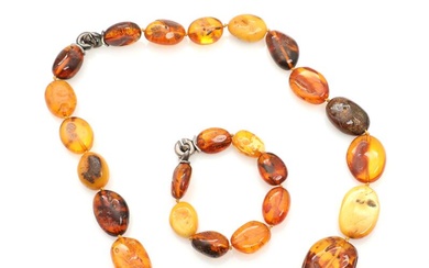 An amber necklace and bracelet with sterling silver clasps. Weight app. 117...