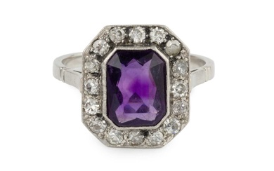 An amethyst and diamond cluster ring, the chamfered rectangular cut...