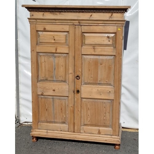 An antique pine two door Wardrobe with dentil carved cornice...
