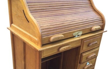 An oak roll-top desk, the tambour enclosing a fitted...