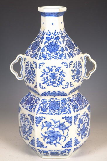 CHINESE BLUE AND WHITE PORCELAIN HEXAGONALLY-PANELLED DOUBLE GOURD-FORM, TWO-HANDLE VASE....