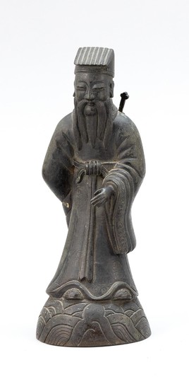 CHINESE BRONZE FIGURE OF A SAGE Standing on a wave-form base. Height 7.25".