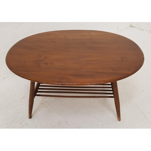 ERCOL OAK OCCASIONAL TABLE with an oval top, standing on tur...