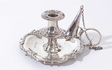 Early Victorian silver taper chamberstick of shaped circular form with foliate scroll borders, loop handle with chain attached snuffer