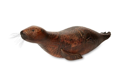 Jeff Soan, an articulated wood model of a seal, 1998, inset eyes and whiskers, signed to the back of one fin, 90cm long (ARR)