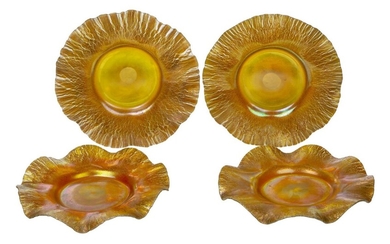 L.C. Tiffany (American), a set of four iridescent glass dishes, Early 20th century, engraved L.C.T, ground out pontil, Each with wavy rim and covered with a gold/orange iridescent surface dispersing on the rim, 17.3 to 17.8 cm diameter (4)