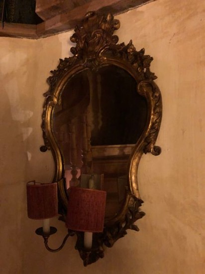 MIRROR made of gilded and carved wood in...