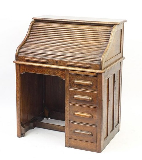 Oak tambour front roll top desk with four drawers to