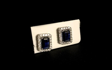 Pair of EARRINGS in white gold adorned with two emerald-cut...