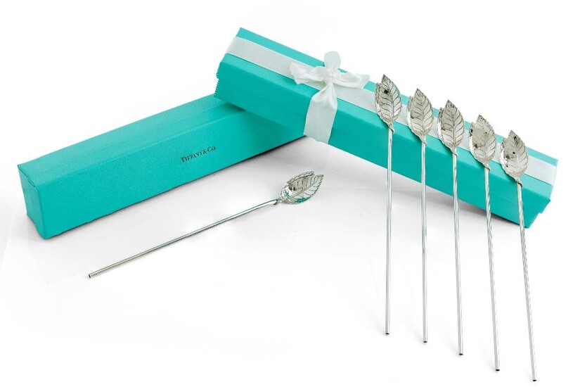 Six cocktail straws retailed by Tiffany & Co., each stamped sterling and signed Tiffany & Co., the straws designed with leaf bowls to hollow stems, 21.2cm long, in two signed Tiffany & Co. boxes