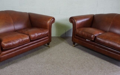 Two Tan Leather Three Seater Sofas with Castor Legs and scroll arms, 170 x 105 x 90 cm