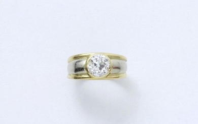 Two-tone 750 thousandths gold ring set with an old cut diamond in a closed setting. French work.