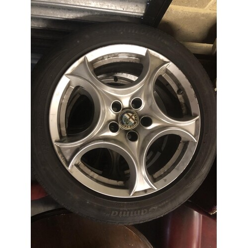 set of 4 alfa romeo alloy wheels- complete with center hubs