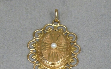 An oval openwork gold (eagle) pendant with a cultured pearl...