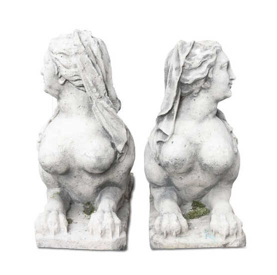 A PAIR OF CARVED STONE SPHINXES, each depicted...
