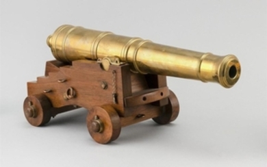 BRASS MODEL OF A 24-POUND LONG GUN Based on plans for cannons used on the U.S.S. Constitution. Wooden carriage with wooden wheels an...