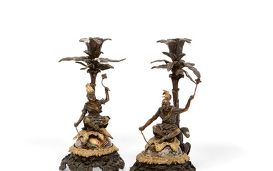 A pair of Continental parcel gilt bronze articulated figural candlesticks