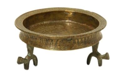 AN ENGRAVED BRASS DISH WITH TRIPOD Iran, 12th...