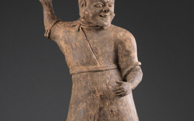 A grey pottery figure of a soldier