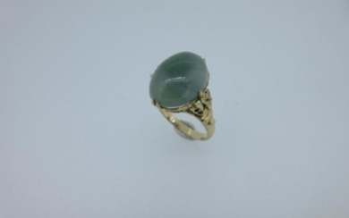 A jadeite jade ring with cast floral shoulders