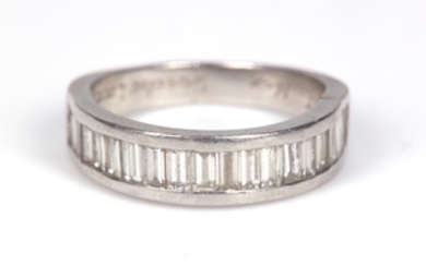 A diamond half-hoop ring, channel-set with baguette-cut diamonds,...