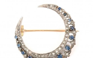A 14 karat gold and silver sapphire and diamond crescent brooch. Featuring thirteen blue sapphires amongst rose cut diamonds. Gross weight: 10.7 g.