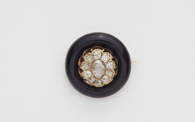 A 14k gold black enamel and diamond circular brooch.