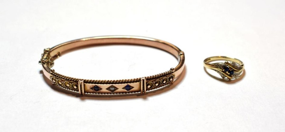 A 9 carat gold sapphire and split pearl bangle; and...