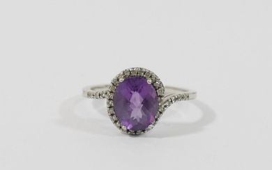 A 9 carat white gold amethyst single stone ring within melee...