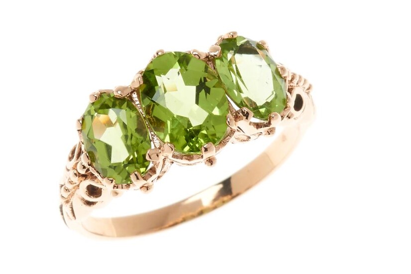 A 9CT GOLD VICTORIAN STYLE PERIDOT RING; set with 3 oval cut peridots in rose gold, size O, wt. 3.25g.