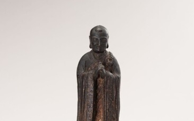A BRONZE FIGURE OF A LUOHAN