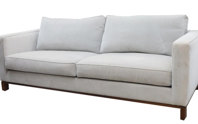 A Blanchard three seat sofa, velour upholstered, raised on oak base, 65cm high, 214cm wide, 100cm deep