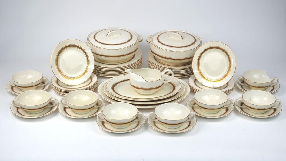 A Cauldon Bristol part dinner service, mid 20th century, of cream ground with gilt Greek key border, underglaze green mark to underside, comprising: two tureens with covers, 22cm diameter, three oval serving platters, the largest 34cm long, eight...