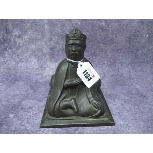 A Chinese XIX Century Bronze Model of a Seated Scholar, lean...