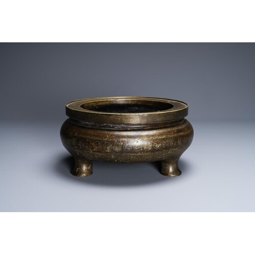 A Chinese parcel-gilt bronze tripod censer, Xuande merk, Qin...